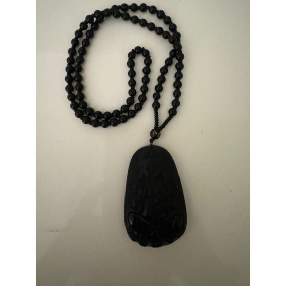 Black obsidian Guanyin pendant necklace featuring Guan Yin goddess.